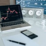 Profissionais do mercado financeiro analisando gráficos de investimentos e tecnologia em telas corporativas